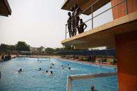 Two teams play water polo during an Awatu Winton Water Polo Club competition at the University of Ghana in Accra, Ghana, Saturday, Jan. 14, 2023. Former water polo pro Asante Prince is training young players in the sport in his father's homeland of Ghana, where swimming pools are rare and the ocean is seen as dangerous. (AP Photo/Misper Apawu)