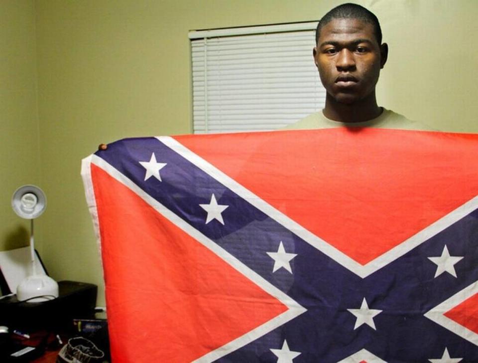 Byron Thomas, then 19 and a student at USCB Beaufort, holds a Confederate Flag in his dormitory room in 2011.