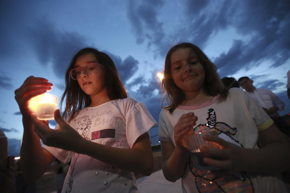 People gather in Juarez, Mexico, Saturday, Aug. 3, 2019, in a vigil for the 3 Mexican nationals who were killed in an El Paso shopping-complex shooting. Twenty people were killed and more than two dozen injured in a shooting Saturday in a busy shopping area in the Texas border town of El Paso, the state’s governor said. (AP Photo/Christian Chavez)