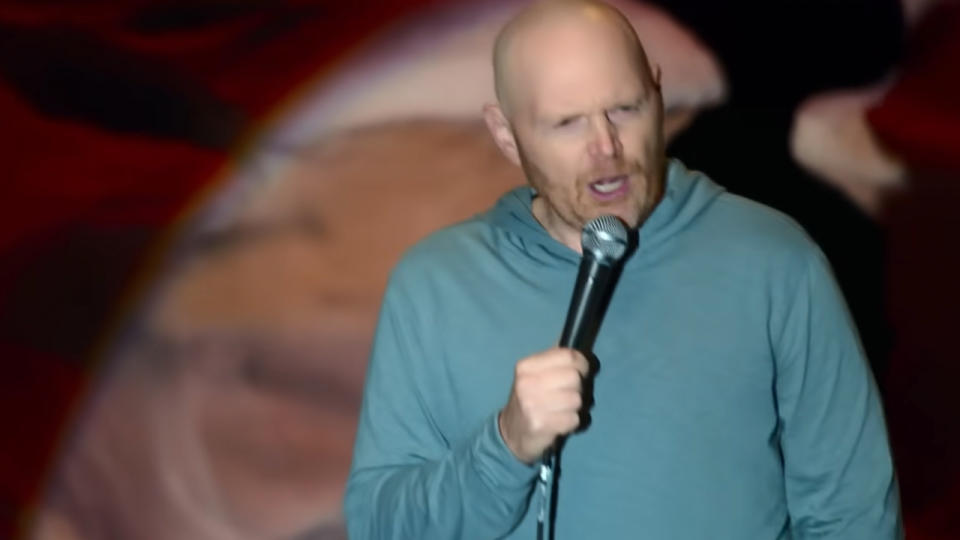 Bill Burr looking angry during his stand up act.