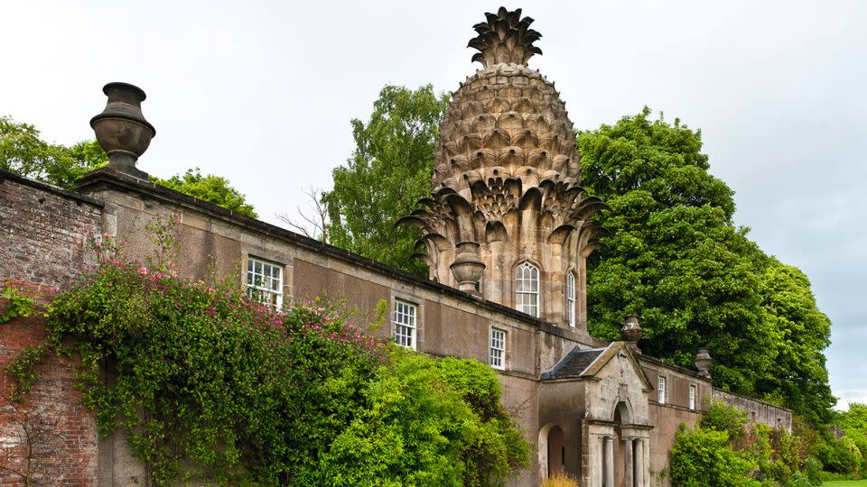 Pineapple designs still survive on some notable buildings across Britain associated with royalty, including The Pineapple House in Dunmore Park, Scotland. - Brandstaetter Images/Getty Images