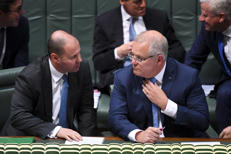 Australian Prime Minister Scott Morrison (right) speaks to Australian Federal Treasurer Josh Frydenberg in Parliament House in Canberra, Wednesday, September 18, 2019. (AAP Image/Lukas Coch)