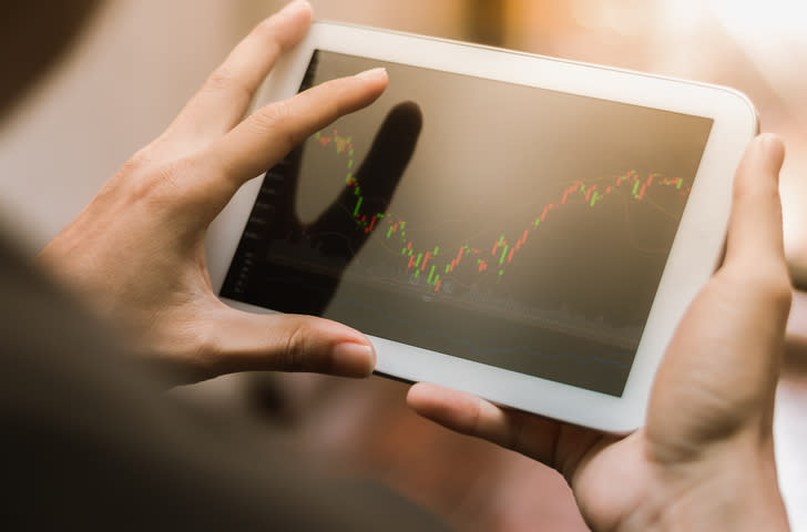 Business man checking stock market on tablet, smartphone