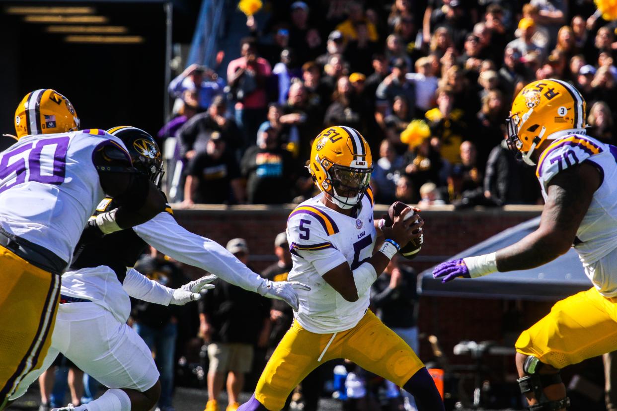 LSU quarterback Jayden Daniels (5) avoids the Missouri pass rush during Missouri's game against LSU at Faurot Field on Oct. 7, 2023, in Columbia, Mo.