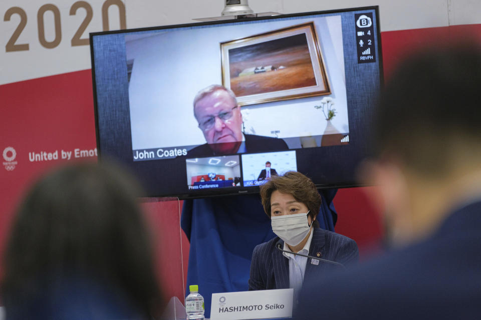 Chairman of the Coordination Commission for the Games of the XXXII Olympiad Tokyo 2020 John Coates, (on screen), and President of the Tokyo 2020 Seiko Hashimoto, right, attend the Tokyo 2020 IOC Coordination Commission press conference on May 21, 2021 in Tokyo. (Nicolas Datiche/Pool Photo via AP)