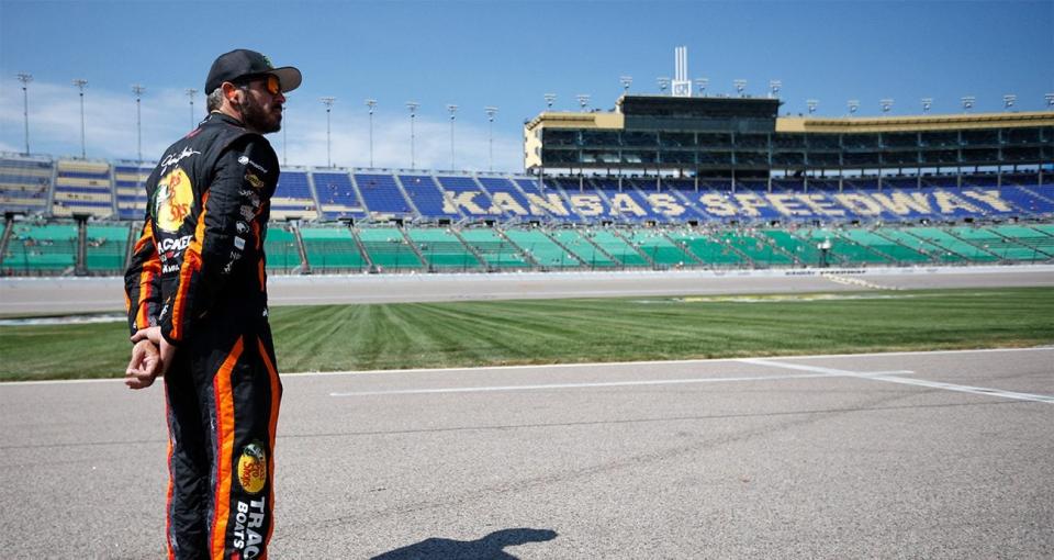 martin truex jr stands at kansas speedway