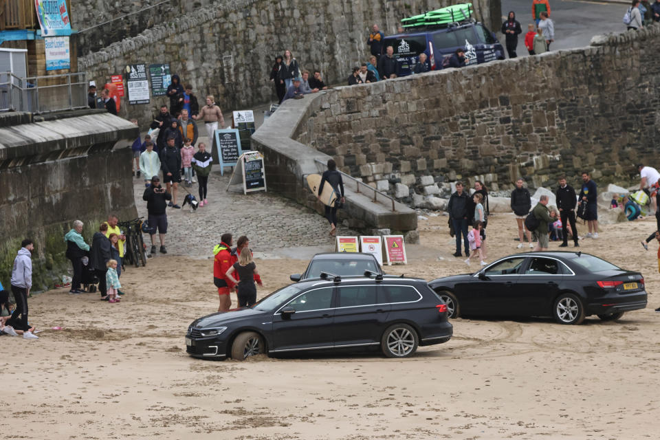 Three cars stuck on Towan Beach in Newquay, Cornwall in August 2023.