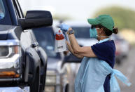 Health officials and members of the military assist during COVID-19 testing, Wednesday, July 8, 2020, at HEB Park in Edinburg, Texas. (Delcia Lopez/The Monitor via AP)