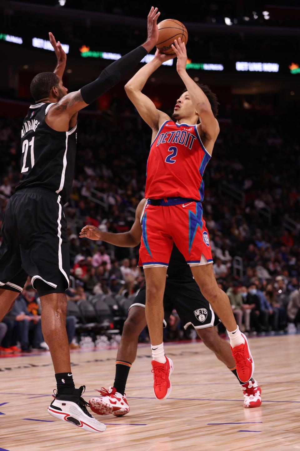 Cade Cunningham of the Detroit Pistons takes a first half shot over LaMarcus Aldridge of the Brooklyn Nets at Little Caesars Arena in Detroit on Friday, Nov. 5, 2021.