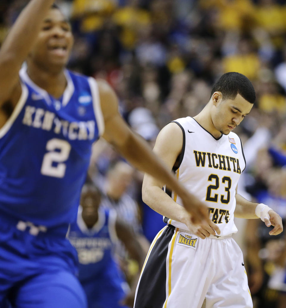 Wichita State guard Fred VanVleet (23) leaves the floor after missing a three-point attempt in the final seconds against Kentucky during the second half of a third-round game of the NCAA college basketball tournament Sunday, March 23, 2014, in St. Louis. Kentucky won 78-76. (AP Photo/Charlie Riedel)