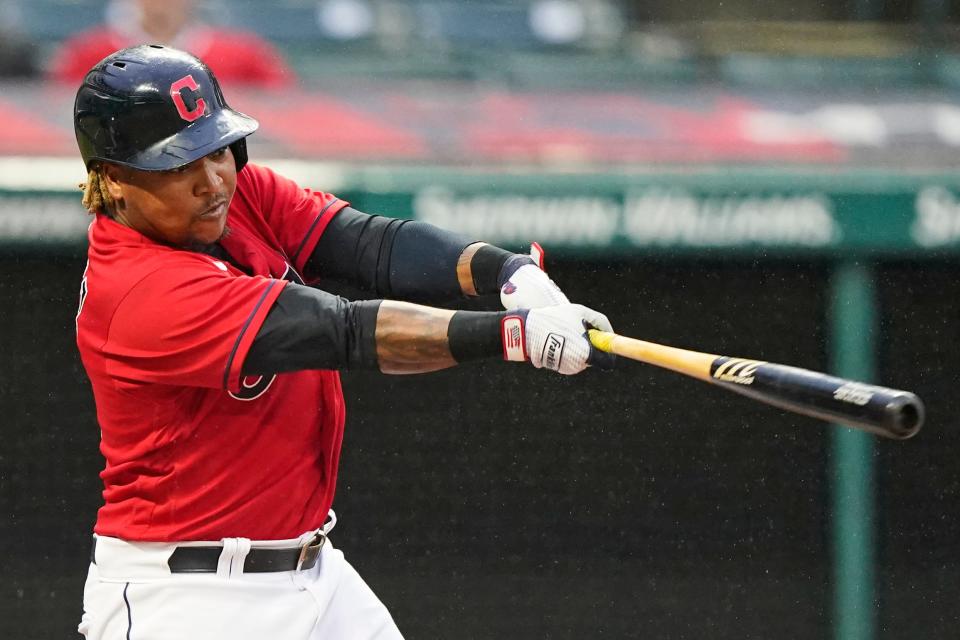 Cleveland Indians' Jose Ramirez hits a single in the first inning of a baseball game against the Kansas City Royals, Tuesday, Sept. 21, 2021, in Cleveland. (AP Photo/Tony Dejak)