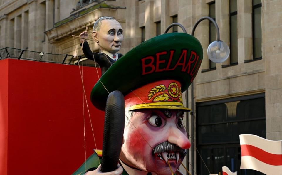 File photo: A carnival float featuring Mr Putin handling Mr Lukashenko like a puppet is seen at a peace march “Freedom for Ukraine” in Cologne, Germany, 28 February 2022 (AFP via Getty Images)