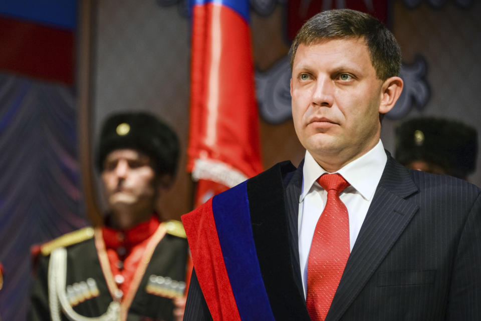 FILE - In this Tuesday, Nov. 4, 2014 file photo, rebel leader Alexander Zakharchenko stands during a swearing in ceremony in Donetsk, Ukraine. The news agency of the Russia-backed separatists fighting in eastern Ukraine's Donetsk region is reporting that separatist leader Alexander Zakharchenko has died in a cafe explosion. Rebel news agency DAN said the Friday, Aug. 31, 2018 explosion tore through a cafe in Donetsk, the region's principal city.(AP Photo/Mstyslav Chernov, file)