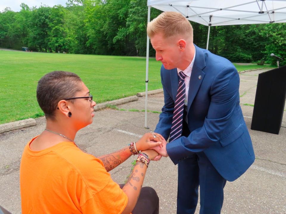 Shawn LaTourette, New Jersey’s environmental protection commissioner, right, holds the hand of Angel Stefancik. (AP)