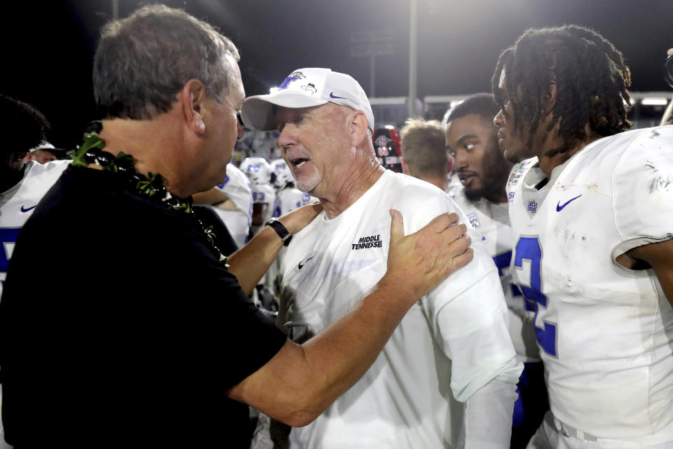 San Diego State head coach Brady Hoke, left, meets Middle Tennessee head coach Rick Stockstill at the end of the Hawaii Bowl NCAA college football game, Saturday, Dec. 24, 2022, in Honolulu. (AP Photo/Marco Garcia)