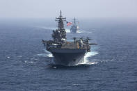 CORRECTS DATE - In this Friday, May 17, 2019, photo released by the U.S. Navy, the amphibious assault ship USS Kearsarge and the Arleigh Burke-class guided-missile destroyer USS Bainbridge sail in formation as part of the USS Abraham Lincoln aircraft carrier strike group in the Arabian Sea. Commercial airliners flying over the Persian Gulf risk being targeted by "miscalculation or misidentification" from the Iranian military amid heightened tensions between the Islamic Republic and the U.S., American diplomats warned Saturday, May 18, 2019, even as both Washington and Tehran say they don't seek war. (Mass Communication Specialist 1st Class Brian M. Wilbur, U.S. Navy via AP)
