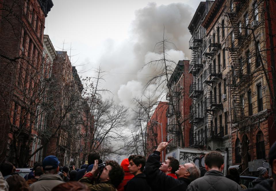 NEW YORK, UNITED STATES - MARCH 26: Smoke rises as the firefighters extinguish a fire caused by a blast occurred at a building in East Village district of New York, United States on March 26, 2015. Local media reports that at least six people were injured but it is unclear if anyone was trapped inside either building. No casualties have been reported. The cause of the explosion will be clear after the investigation. (Photo by Cem Ozdel/Anadolu Agency/Getty Images)