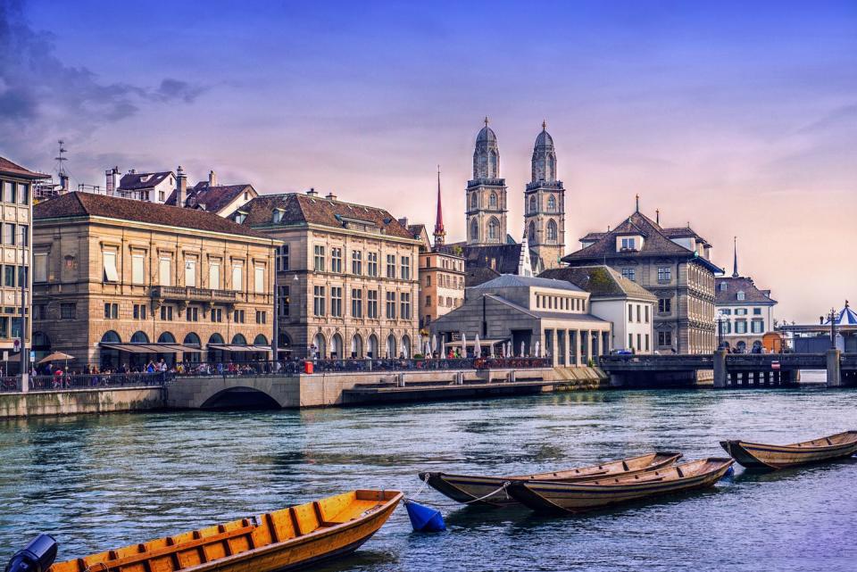 grossmunster cathedral with river limmat in zurich at sunset