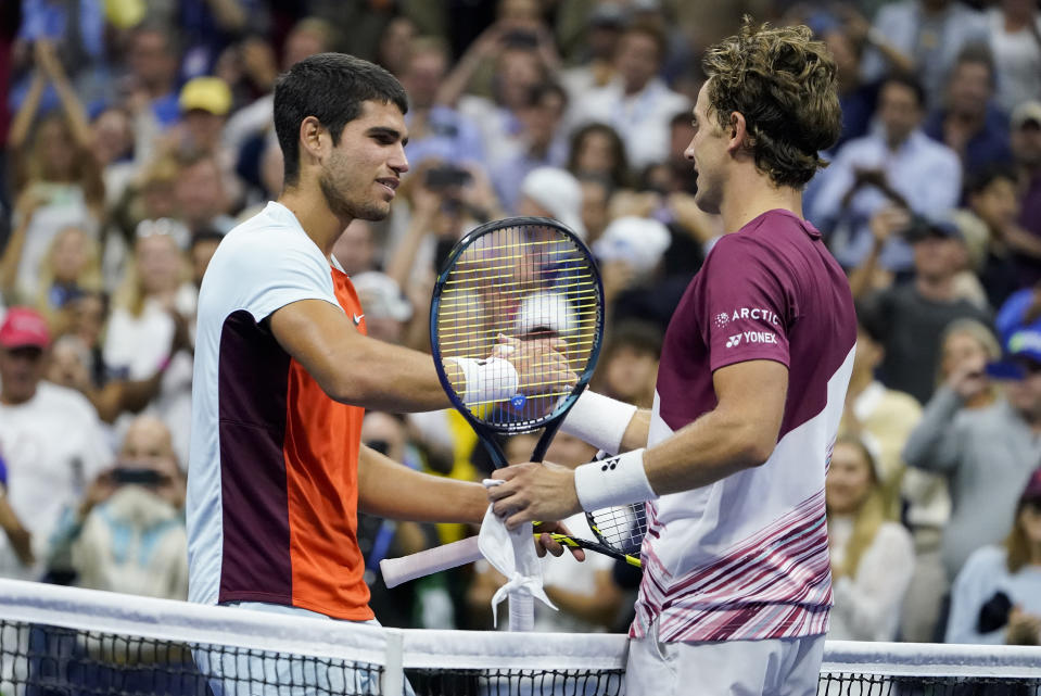 Carlos Alcaraz, of Spain, left, shakes hands with Casper Ruud, of Norway, after winning the men's singles final of the U.S. Open tennis championships, Sunday, Sept. 11, 2022, in New York. (AP Photo/John Minchillo)