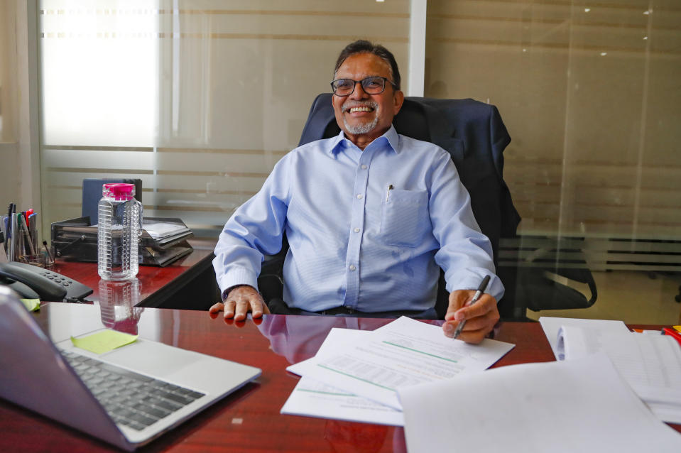 Rashmi Shah, CP Solar's Managing Director, smiles at his desk in Nairobi, Kenya, Friday, Sept. 1, 2023. Access to electricity remains a major challenge for over half a billion people in sub-Saharan Africa, and power outages are common. In South Africa and Kenya, solar is being used to power major businesses. (AP Photo/Brian Inganga)