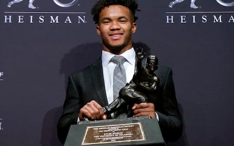 Oklahoma quarterback Kyler Murray holds the Heisman Trophy after winning the award in New York. Murray is a prospect in the 2019 NFL Draft - Credit: AP