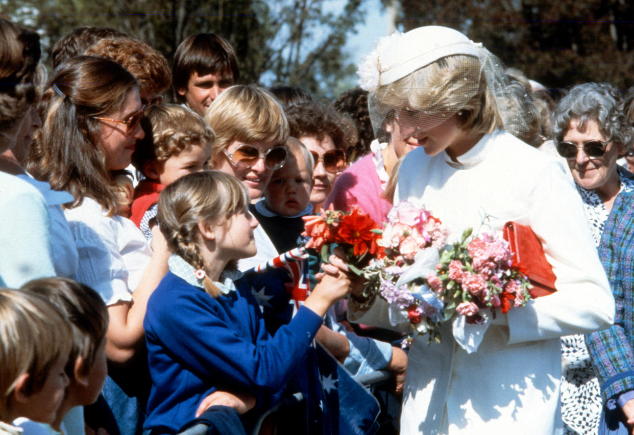 LAUNCESTON, AUSTRALIA - MARCH 31: Diana, Princess of Wales, wearing a cream gabardine suit designed by Jasper Conran with a matching hat with flowers and a veil designed by John Boyd, speaks to well-wishers during a walkabout in Launceston on March 31, 1983 in Tasmania, Australia. (Photo by Anwar Hussein/Getty Images)