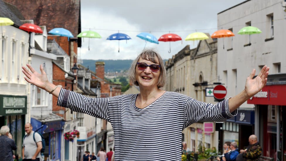 Jane Roberts stands under the neurodiversity umbrella project in the town of Stroud
