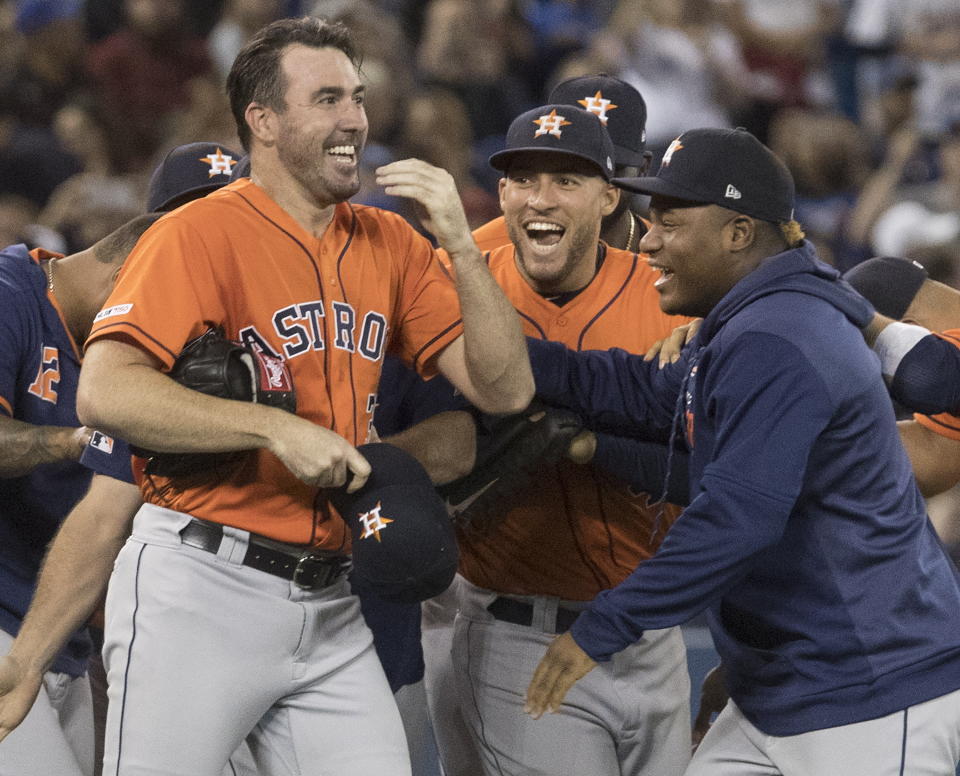 Houston Astros starting pitcher Justin Verlander, left, is mobbed by teammates after pitching a no-hitter against the Toronto Blue Jays in a baseball game in Toronto, Sunday, Sept. 1, 2019. (Fred Thornhill/The Canadian Press via AP)