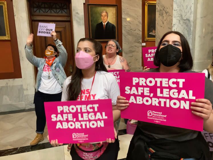 Abortion-rights supporters chant their objections at the Kentucky Capitol on Wednesday, April 13, 2022, in Frankfort, Ky., as Kentucky lawmakers debate overriding the governor's veto of an abortion measure. The bill would put new restrictions on abortion, including banning the procedure after 15 weeks of pregnancy. (AP Photo/Bruce Schreiner)