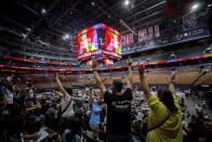 FILE - In this Sunday, June 27, 2021 file photo, vaccine recipients cheer for giveaways as the number of 25,000 doses administered is shown on a big screen at the mass vaccination clinic at Scotiabank Arena in Toronto. The number counts a new claimed record of COVID-19 vaccinations administered at one site in a day. (Cole Burston/The Canadian Press via AP)