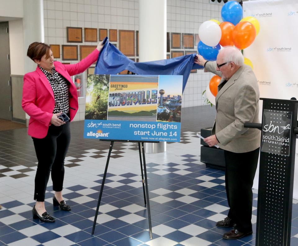 Bethany Hartley, president of the South Bend Elkhart Regional Partnership, and David Sage, president of the St. Joseph County Airport Board, unveils a poster Monday, Feb. 12, 2024, at South Bend International Airport for the announcement that Allegiant Airlines will offer South Bend flights to and from Knoxville, Tenn., starting June 14.