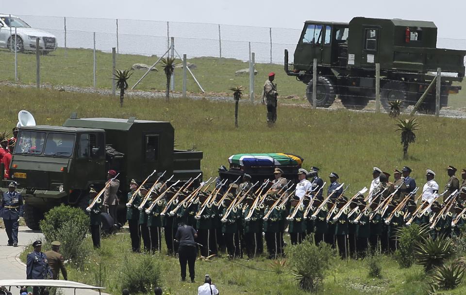 Former South African President Nelson Mandela's coffin arrives at the family gravesite for burial at his ancestral village of Qunu in the Eastern Cape province