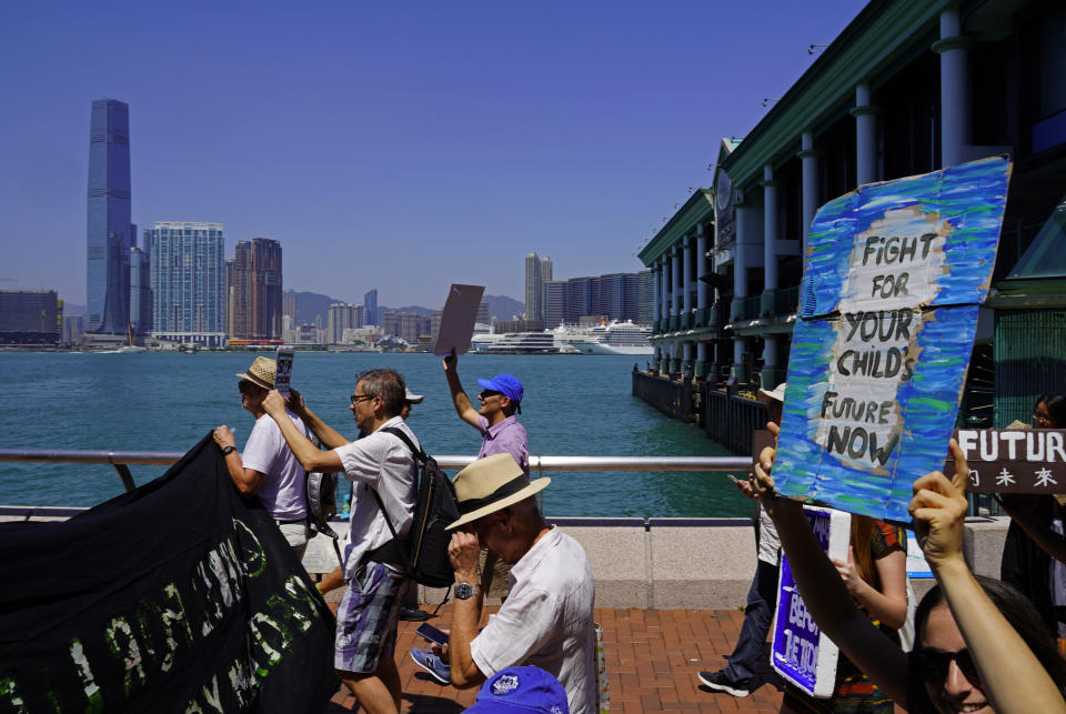 Protesters with placards participate in the Global Strike 4 Climate rally in Hong Kong, Friday, Sept. 20, 2019. Protesters are gathering as a day of worldwide demonstrations begins ahead of a U.N. climate summit in New York. (AP Photo/Vincent Yu)