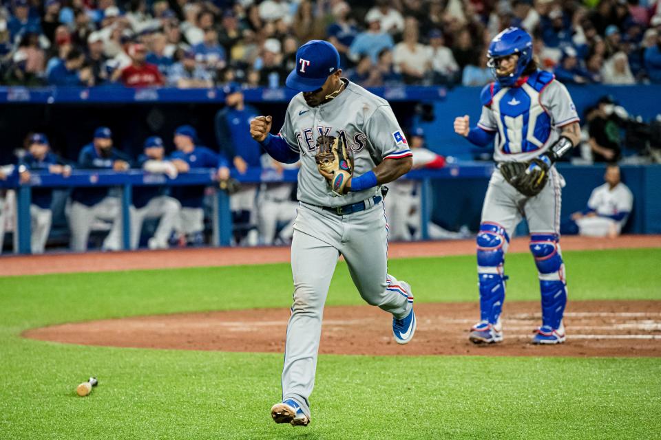 Texas Rangers'  Andy Ibanez (77) celebrates after throwing out Toronto Blue Jays George Springer during the fourth inning of a baseball game in Toronto on Saturday, April 9, 2022. (Christopher Katsarov/The Canadian Press via AP)