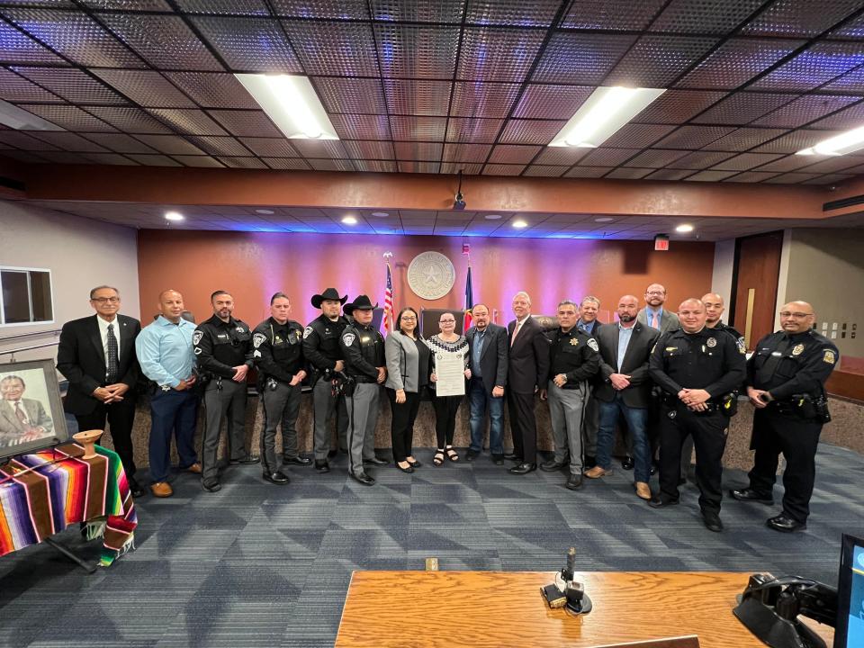 Fallen El Paso County Sheriff's Office Deputy Peter John Herrera's family, along with members of the El Paso County's Sheriff's Office and El Paso County Sheriff’s Officers Association, pose for a photo with El Paso County commissioners after the court adopted a resolution recognizing Sunday, March 26, 2023, as Deputy Peter John Herrera Day.