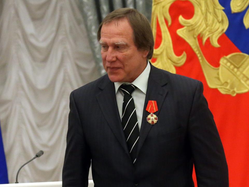 Russian President Vladimir Putin (L) awards businessman and cellist Sergei Roldugin (R) at the Kremlin in 2016.