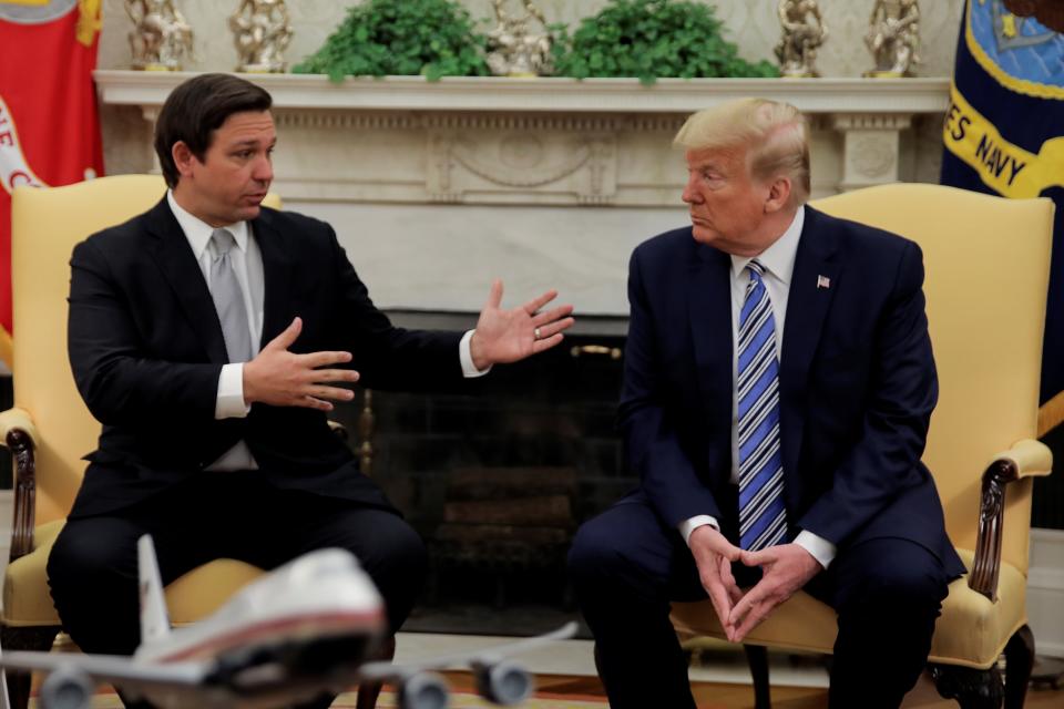 Former US president Donald Trump meets with Florida Governor DeSantis about coronavirus response at the White House in Washington (REUTERS)