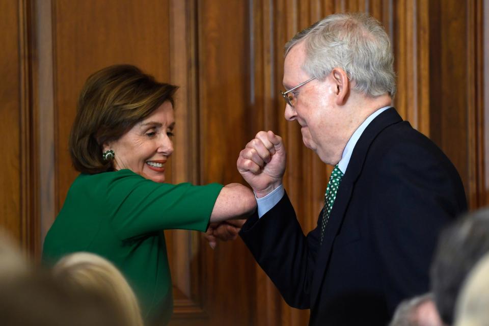 House Speaker Nancy Pelosi of Calif., left, and Senate Majority Leader Mitch McConnell of Ky., right, bump elbows as they attend a lunch with Irish Prime Minister Leo Varadkar on Capitol Hill in Washington, Thursday, March 12, 2020.