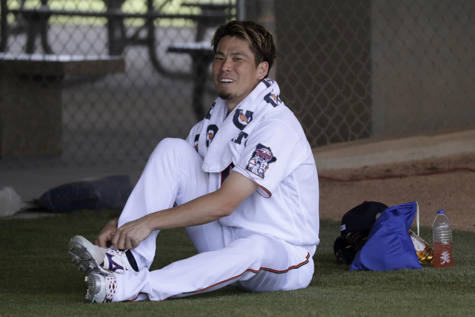 Minnesota Twins starting pitcher Kenta Maeda (18) ties his shoe before facing the Boston Red Sox a spring training baseball game Monday, Feb. 24, 2020, in Fort Myers, Fla. (AP Photo/John Bazemore)