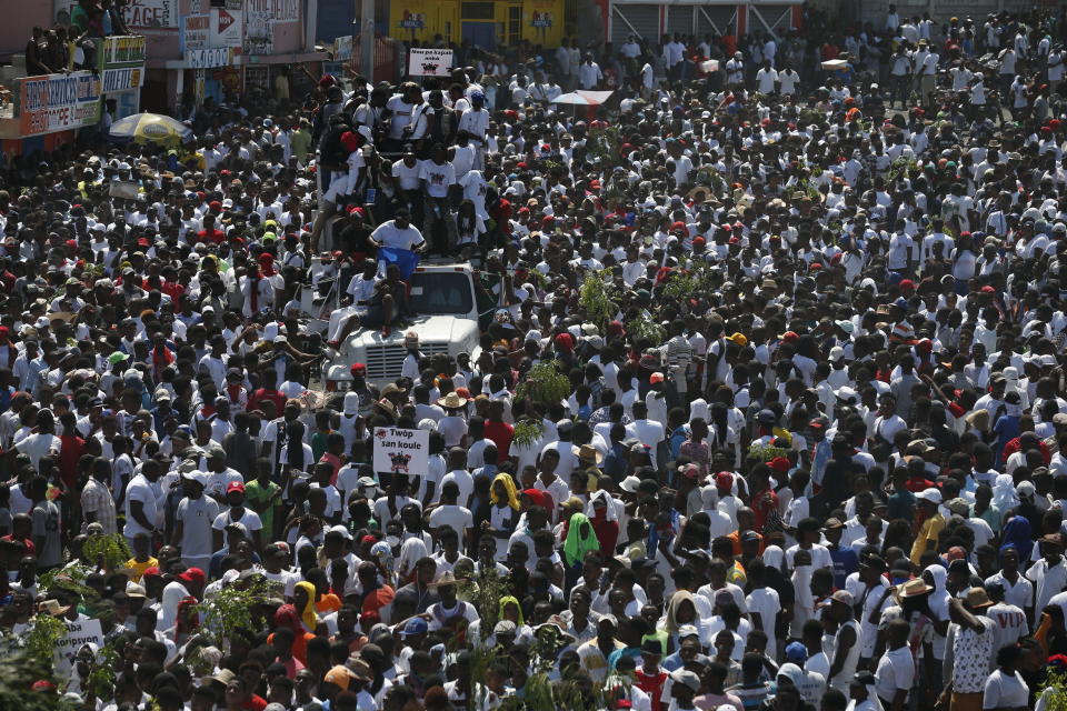 Protesters led by the art community demand the resignation of Haitian President Jovenel Moise as they march through Port-au-Prince, Haiti, Sunday, Oct. 13, 2019. Protests have paralyzed the country for nearly a month, shuttering businesses and schools. (AP Photo/Rebecca Blackwell)