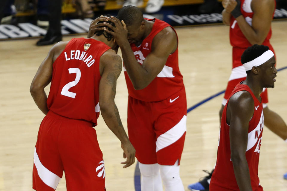 OAKLAND, CALIFORNIA - JUNE 13: Kawhi Leonard #2 and Serge Ibaka #9 of the Toronto Raptors celebrate late in the game against the Golden State Warriors during Game Six of the 2019 NBA Finals at ORACLE Arena on June 13, 2019 in Oakland, California. NOTE TO USER: User expressly acknowledges and agrees that, by downloading and or using this photograph, User is consenting to the terms and conditions of the Getty Images License Agreement. (Photo by Lachlan Cunningham/Getty Images)