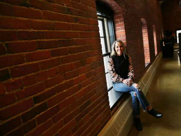Portsmouth business owner Jessica Kaiser shows off part of her building in the city's West End that will be converted to wedding and event space.