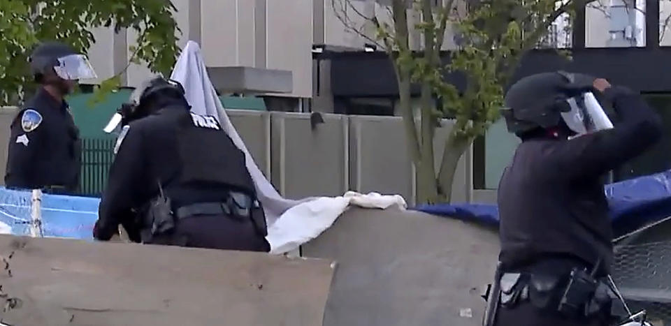 In this image made from video provided by WXYZ, police dismantle a pro-Palestinian encampment at Wayne State University in Detroit on Thursday, May 30, 2024. The police action came two days after the school suspended in-person classes and encouraged staff to work remotely to avoid any problems with the protesters' encampment. (WXYZ via AP)