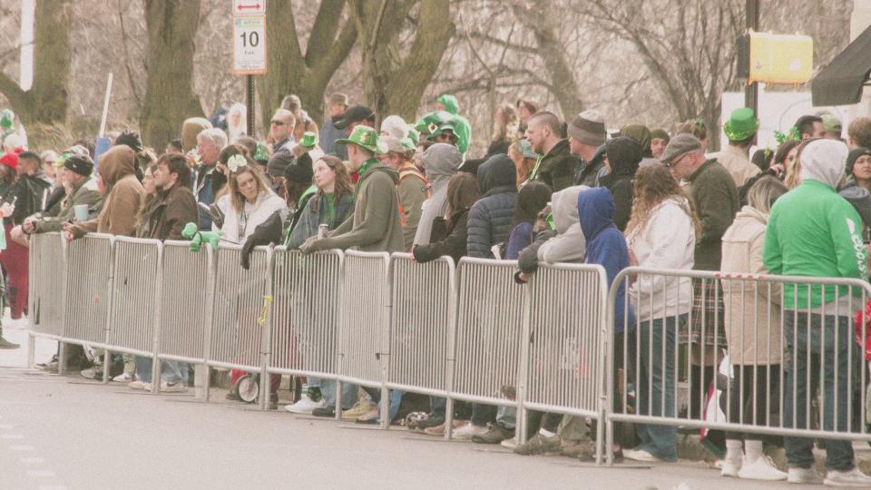 People line the streets awaiting the St. Patrick's Day parade on East Avenue.