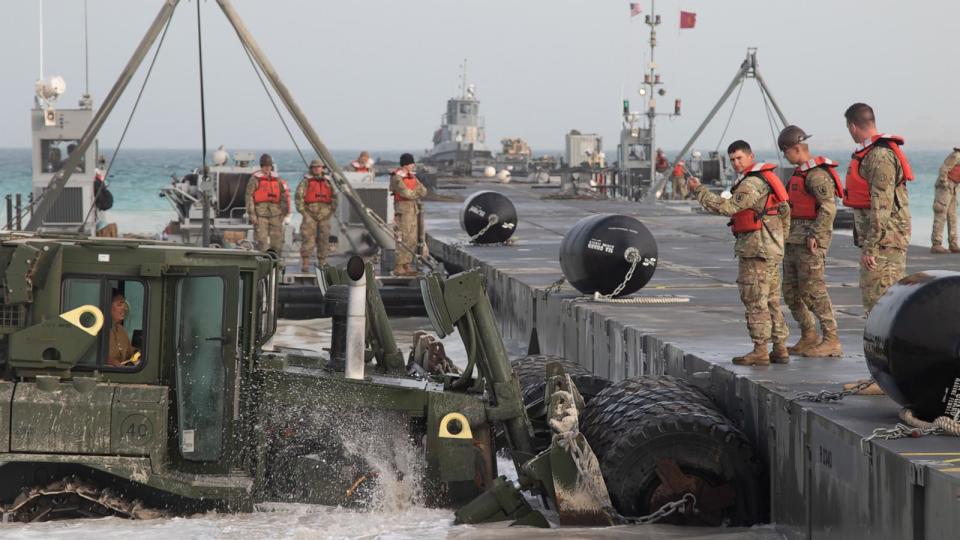 PHOTO: U.S. Army soldiers along with U.S. Navy Seabees align the Modular Causeway System of the Trident Pier in preparation for Iron Union 13 and Native Fury 20 in the United Arab Emirates, Mar 9, 2020. (Maj. Dino De La Hoya/U.S. Army, FILES)