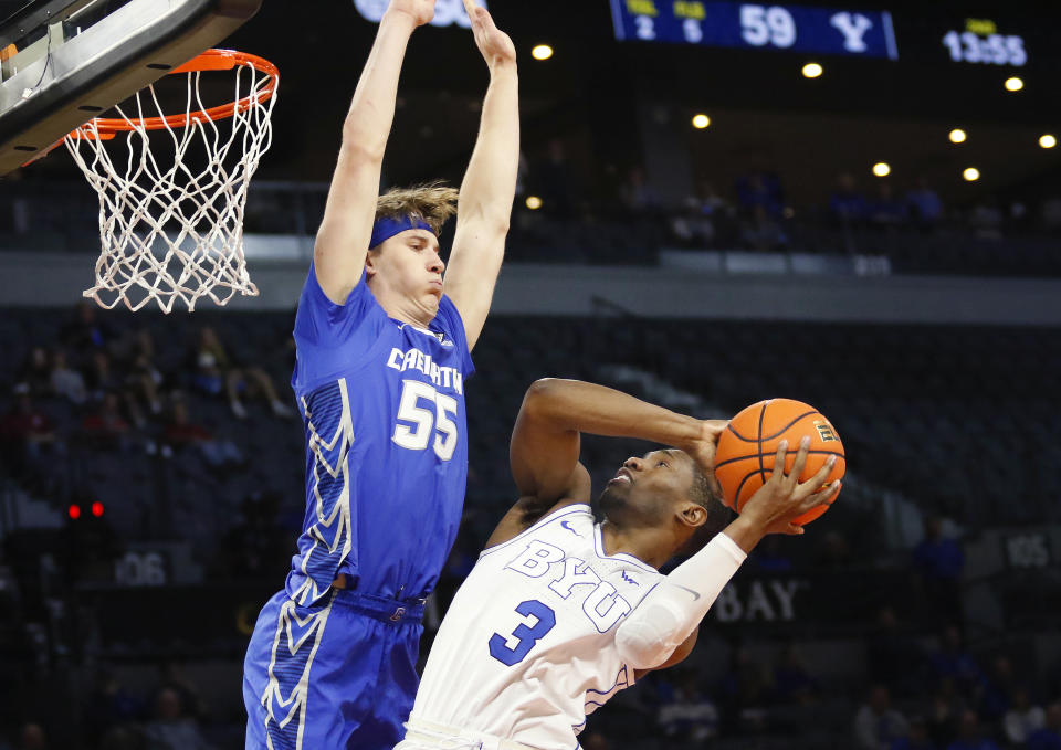 Creighton guard Baylor Scheierman (55) goes up to block BYU guard Rudi Williams (3) during the second half of an NCAA college basketball game Saturday, Dec. 10, 2022, in Las Vegas. BYU won 83 to 80. (AP Photo/Ronda Churchill)