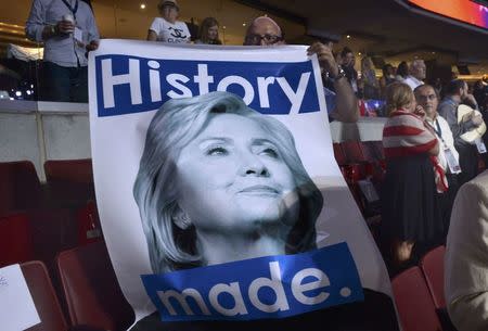 A delegate holds a Hillary Clinton poster at the Democratic National Convention in Philadelphia, Pennsylvania. U.S. July 28, 2016. REUTERS/Charles Mostoller