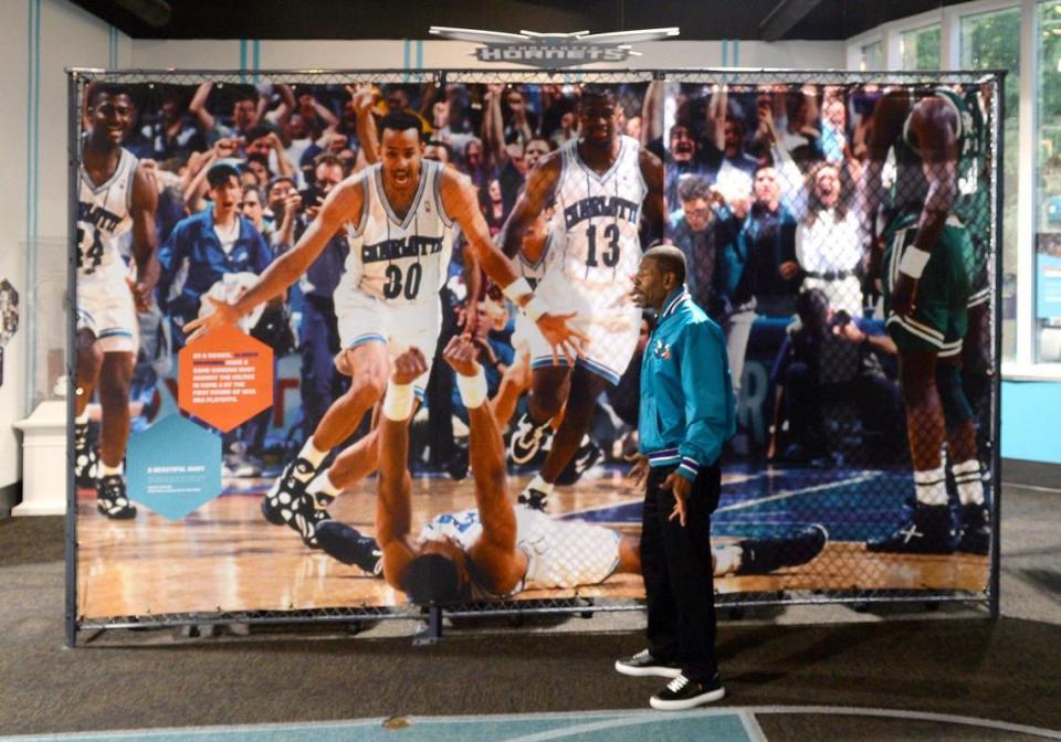 Muggsy Bogues talked about Alonzo Mourning’s game-winning shot against the Boston Celtics on the exhibit behind him.