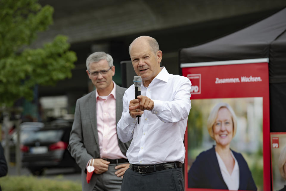 Olaf Scholz, top canditate of the German Social Democrats, gestures as he speaks at an election event of his party at a parking lot of a supermarket in Ludwigsfelde, Germany, Saturday, Aug. 21, 2021. A large chunk of the German electorate remains undecided going into an election that will determine who succeeds Angela Merkel as chancellor after 16 years in power. Recent surveys show that support for German political parties has flattened out, with none forecast to receive more than a quarter of the vote. (Paul Zinken/dpa via AP)
