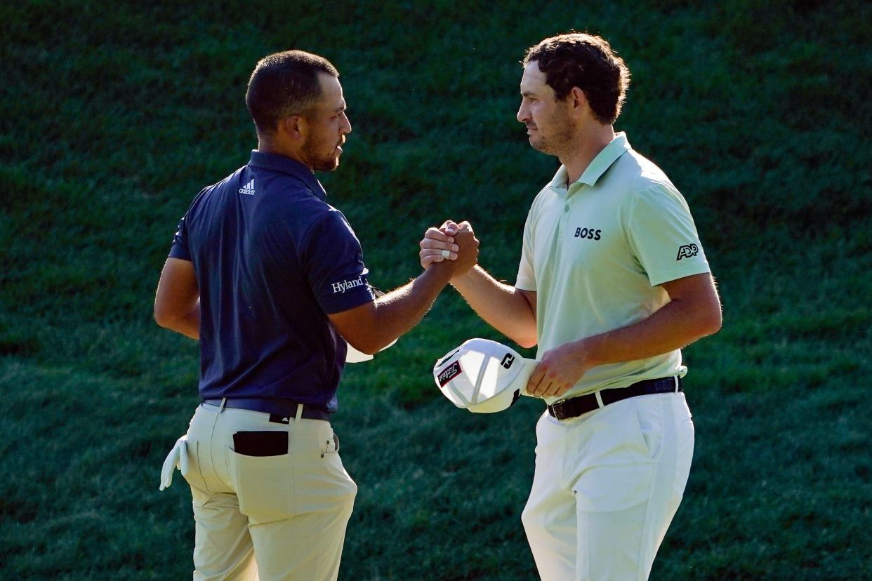 Xander Schauffele, left, and Patrick Cantlay shake hands after finishing the third round of the Travelers Championship golf tournament at TPC River Highlands, Saturday, June 25, 2022, in Cromwell, Conn. Schauffele finished one stroke ahead of Cantley for the lead heading into the final round on Sunday. (AP Photo/Seth Wenig)